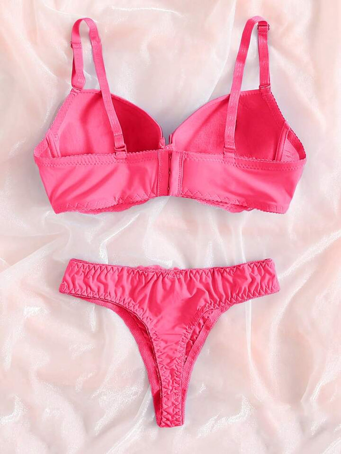 Pink bra and panties set on a soft pink background