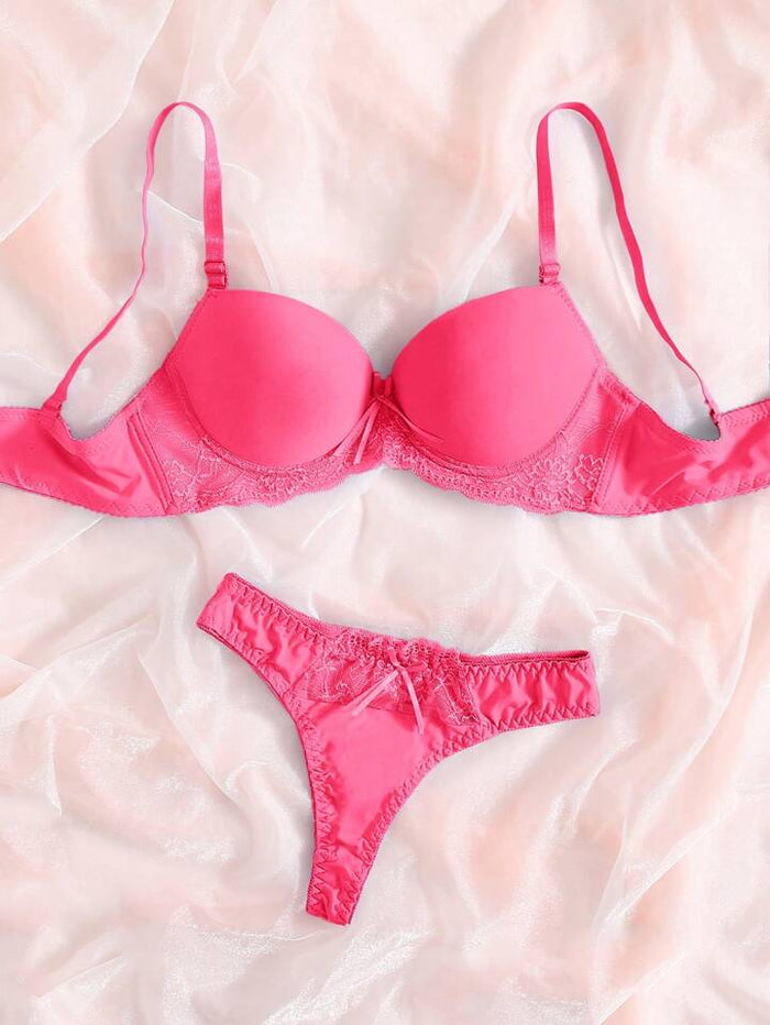 Pink bra and panties set on a soft pink background
