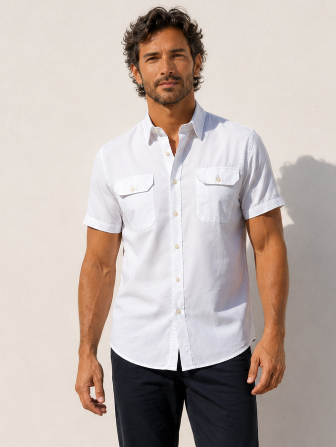 Man wearing a white short-sleeve shirt against a plain background